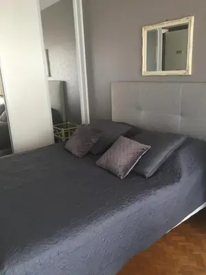 a bed with two pillows on it in a bedroom at Lou Suquetan in Cannes