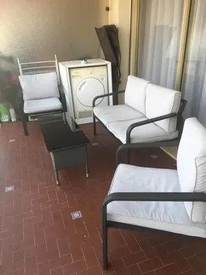 a room with chairs and a tv and a table at Lou Suquetan in Cannes