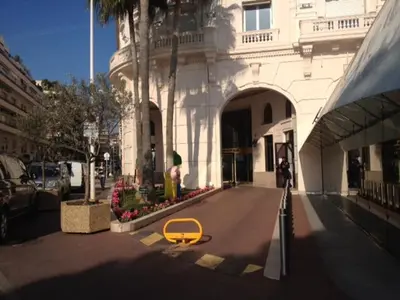 a yellow bench in a street in front of a building at Studio Cannes Croisette in Cannes