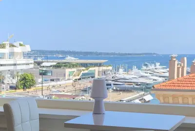 a view of a harbor from a room with a table at La Goelette - Palais des Festivals in Cannes