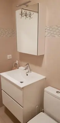 a bathroom with a white sink and a toilet at La Goelette - Palais des Festivals in Cannes