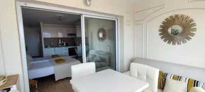a living room with a room with a bed and a mirror at La Goelette - Palais des Festivals in Cannes