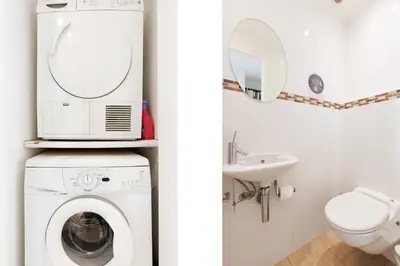 a bathroom with a washing machine and a sink at Mer du Sud 4 YourHostHelper in Cannes
