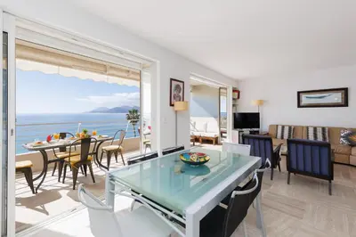 a living room with a view of the ocean at Mer du Sud 4 YourHostHelper in Cannes