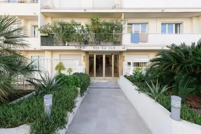 a building with a walkway in front of it at Mer du Sud 4 YourHostHelper in Cannes