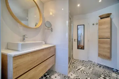 a bathroom with a sink and a mirror at IMMOGROOM - Sea view apartment - 3 min from beach - AC in Cannes