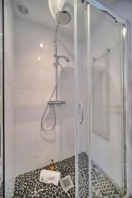 a bathroom with a shower with a glass door at IMMOGROOM - Sea view apartment - 3 min from beach - AC in Cannes