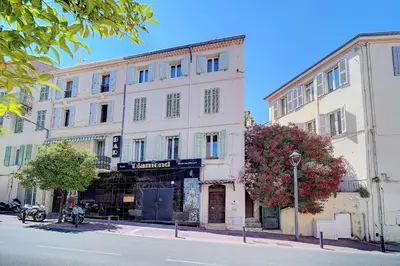 a large white building on a city street at IMMOGROOM - Sea view apartment - 3 min from beach - AC in Cannes