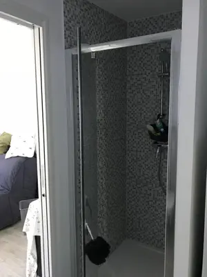 a shower with a glass door in a bathroom at Les fleurs in Cannes