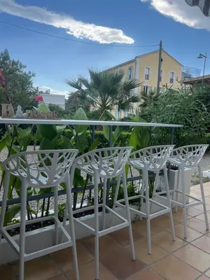 a group of white chairs and a table on a patio at Winter Palace Cannes in Cannes