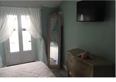 a bedroom with a mirror and a bed and a dresser at Winter Palace Cannes in Cannes