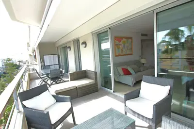 a balcony with chairs and a couch on a balcony at Fully equipped apartment with large terrace lounge area in Cannes