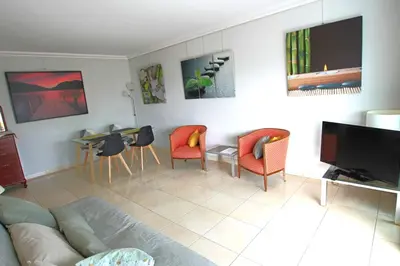 a living room with a couch and chairs and a table at Fully equipped apartment with large terrace lounge area in Cannes