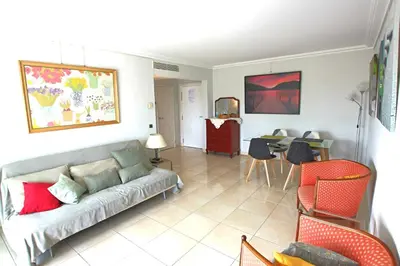 a living room with a couch and a table at Fully equipped apartment with large terrace lounge area in Cannes