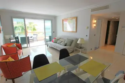 a living room with a glass table and a couch at Fully equipped apartment with large terrace lounge area in Cannes