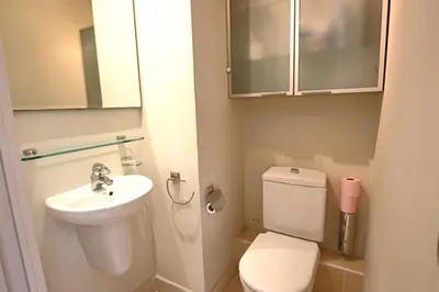 a small bathroom with a toilet and a sink at Fully equipped apartment with large terrace lounge area in Cannes