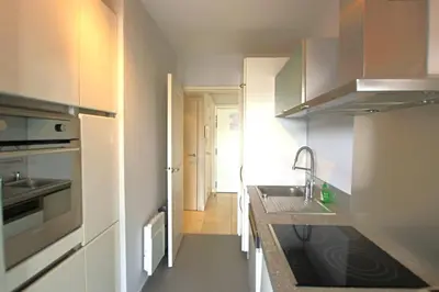 a small kitchen with a sink and a counter at Fully equipped apartment with large terrace lounge area in Cannes
