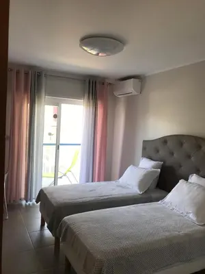 a hotel room with two beds and a window at 2BDR Reine Astrid in Cannes