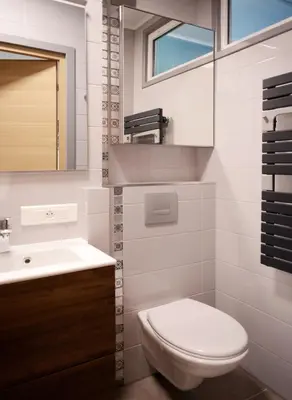 a white bathroom with a toilet and a sink at 2BDR Reine Astrid in Cannes