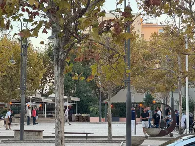 a park with trees and people walking on a sidewalk at 2BDR Reine Astrid in Cannes