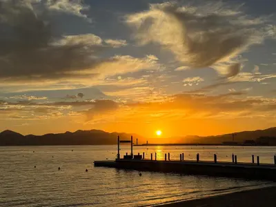 a sunset over a body of water with a pier at 2BDR Reine Astrid in Cannes