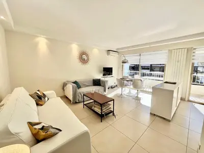 a living room with a couch and a table at Branly by Welcome to Cannes in Cannes