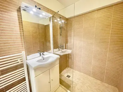 a bathroom with a sink and a mirror and a shower at Branly by Welcome to Cannes in Cannes