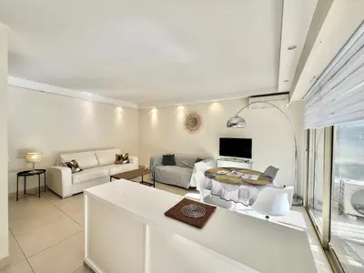 a living room with a couch and a table at Branly by Welcome to Cannes in Cannes
