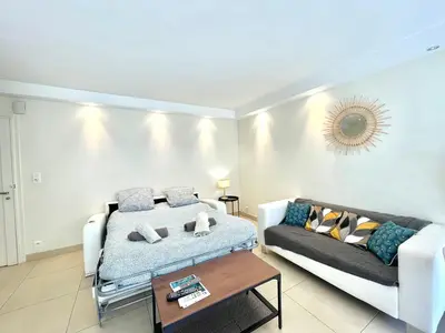 a living room with a bed and a couch at Branly by Welcome to Cannes in Cannes