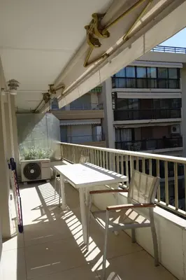 a balcony with a table and chairs on a building at Branly by Welcome to Cannes in Cannes