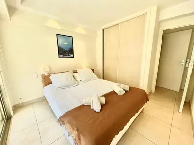 a bedroom with a bed with towels on it at Branly by Welcome to Cannes in Cannes