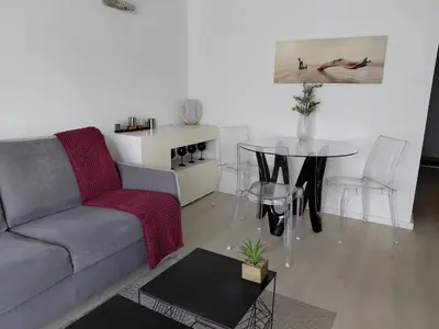 a living room with a couch and a table at Palm beach Cannes Azur in Cannes