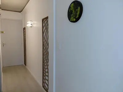 a clock on a wall next to a hallway at Palm beach Cannes Azur in Cannes