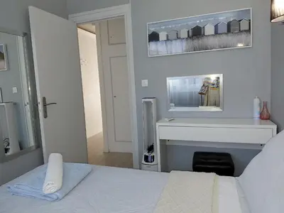 a bedroom with a bed and a fireplace and a mirror at Palm beach Cannes Azur in Cannes