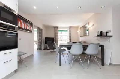 a kitchen and dining room with a table and chairs at Carlton area: New 2 beds / 2 baths in Cannes