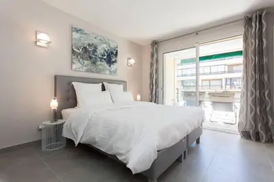 a bedroom with a large bed and a large window at Carlton area: New 2 beds / 2 baths in Cannes