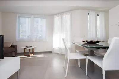 a white living room with a table and chairs at MARTINEZ AREA: NEW 2BEDS/2BATHS in Cannes
