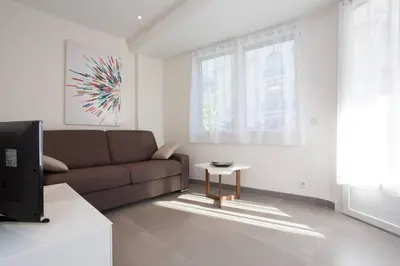 a living room with a couch and a table at MARTINEZ AREA: NEW 2BEDS/2BATHS in Cannes