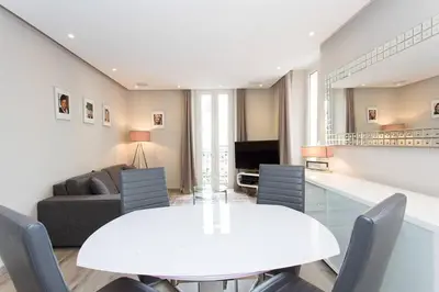 a living room with a white table and chairs at 1 bedroom in front of the Palais! in Cannes