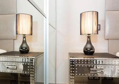 a lamp on a table next to a mirror at 1 bedroom in front of the Palais! in Cannes