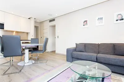 a living room with a couch and a table at 1 bedroom in front of the Palais! in Cannes