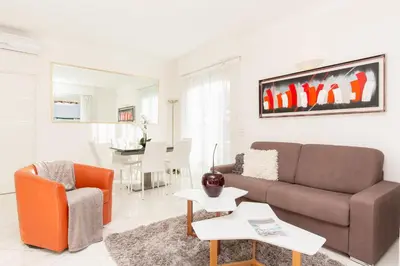 a living room with a couch and a table at MARIOTT AREA: SUNNY 2 BEDS /2 BATHS in Cannes