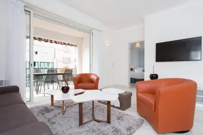 a living room with a couch and a table at MARIOTT AREA: SUNNY 2 BEDS /2 BATHS in Cannes