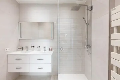 a white bathroom with a sink and a shower at MARIOTT AREA: SUNNY 2 BEDS /2 BATHS in Cannes