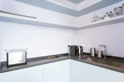a kitchen with white cabinets and a sink at Pure & chic 2beds/2baths in centre! in Cannes
