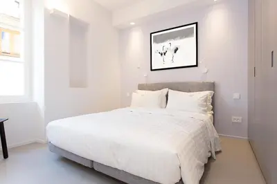 a white bedroom with a large bed with white sheets at Pure & chic 2beds/2baths in centre! in Cannes