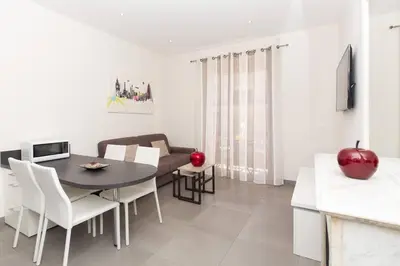 a kitchen and dining room with a table and chairs at Palais Miramar: 1 bed side sea view in Cannes