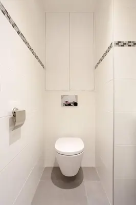 a white bathroom with a toilet and a glass shower at Palais Miramar: 1 bed side sea view in Cannes
