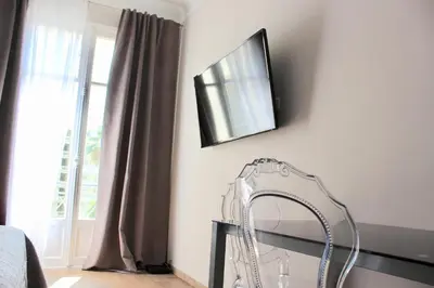 a mirror on a wall next to at New - cosy & nice Apartment in Palais Miramar in Cannes