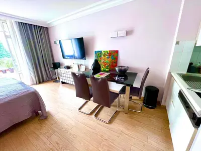 a room with a table and chairs and a kitchen at New - cosy & nice Apartment in Palais Miramar in Cannes